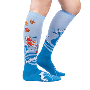 Lifestyle shot of a person wearing the 'Beauty in Water' knee-high socks, showcasing the design and fit.