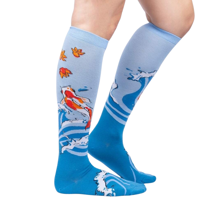 Lifestyle shot of a person wearing the 'Beauty in Water' knee-high socks, showcasing the design and fit.