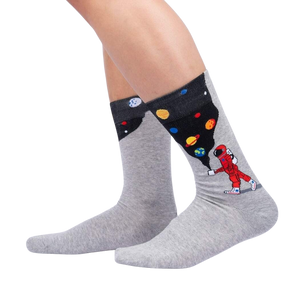 Lifestyle shot showing the 'Moon Walk in the Morning' socks on a person's legs against a black background.