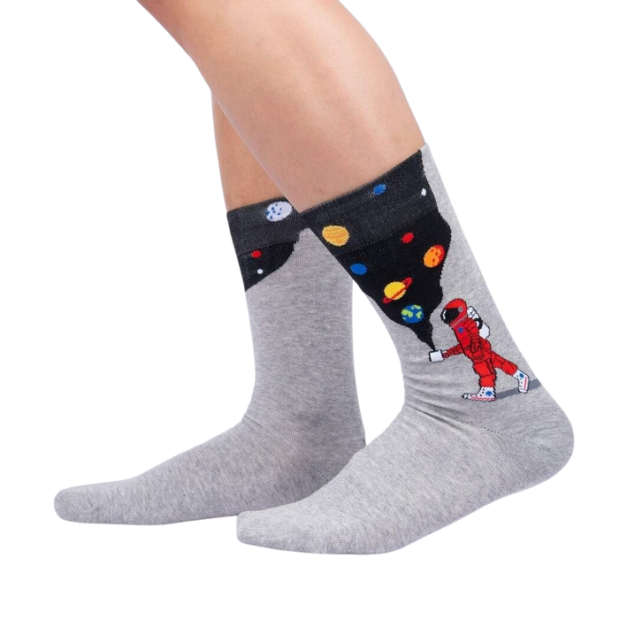 Lifestyle shot showing the 'Moon Walk in the Morning' socks on a person's legs against a black background.