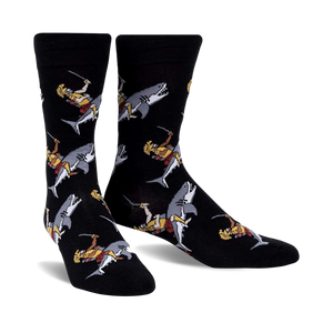 Pair of black crew socks featuring a repeating pattern of gladiators riding sharks.  The gladiators are depicted in gold, red, and white.