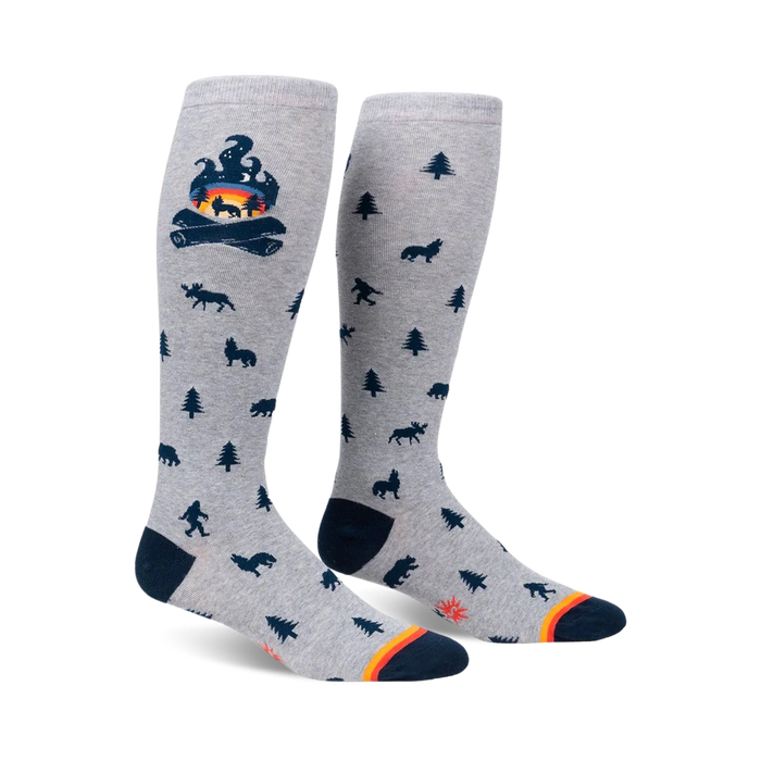 Knee-high socks in grey with a campfire and woodland creature design.  Dark blue and orange accents.