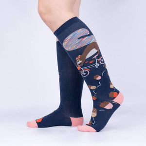 Lifestyle shot showing the 'Feeling Squirrelly' knee-high socks on a person's legs against a light gray background.