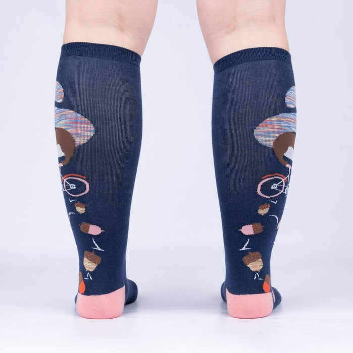 Rear view of the 'Feeling Squirrelly' knee-high socks on a person's legs, highlighting the full design on both socks.