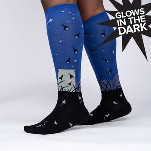 Lifestyle shot showing the Nightlight socks on a model's legs, highlighting their glow-in-the-dark feature.