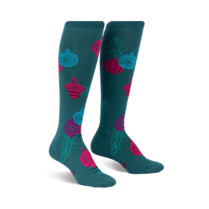 teal knee-high women's socks featuring a pattern of christmas ornaments and pine sprigs.  