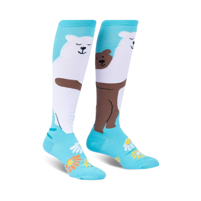 Pair of knee-high socks; teal background with white polar bear and brown bear hugging; daisies at the bottom.