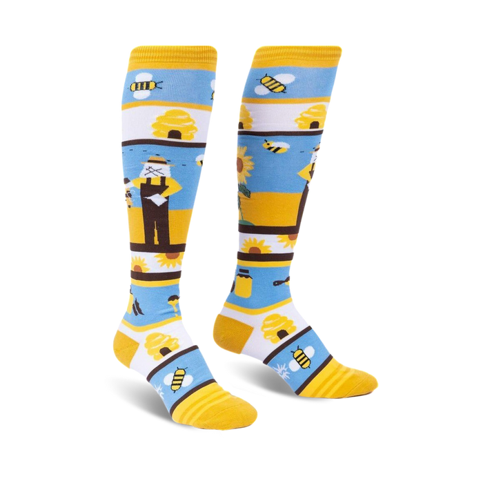 yellow knee-high socks with blue stripes and a bee-themed pattern including bees, sunflowers, a beekeeper, and a beehive for women.  