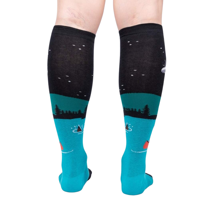 Rear view of the socks highlighting the full design. The socks are teal and black and glow in the dark.