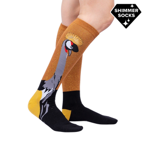 Lifestyle shot showing the Crowned Crane Shimmer socks on a model's legs.