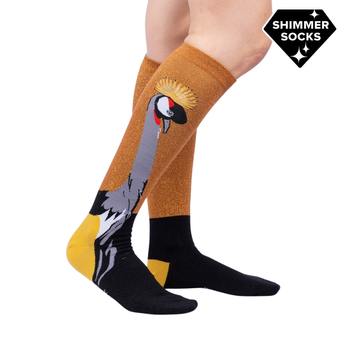 Lifestyle shot showing the Crowned Crane Shimmer socks on a model's legs.