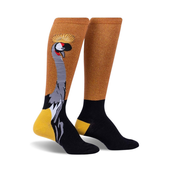 Pair of knee-high socks; gold shimmer, black and mustard yellow accents; crowned crane graphic.
