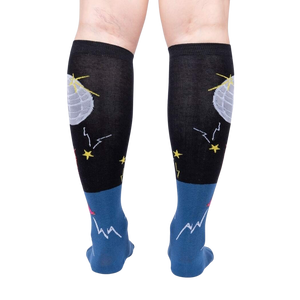 Rear view of Disco Nut! socks on a person's legs; highlighting the full sock design and color scheme.