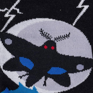 Close-up detail shot focusing on the Mothman's face and the intricate design on the sock.