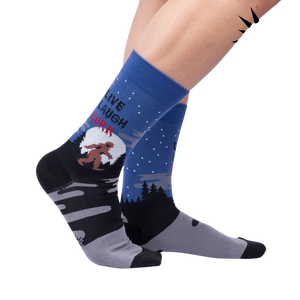 Lifestyle shot: Model wearing the 'Live, Laugh, Lurk' socks, showcasing their fit and design.