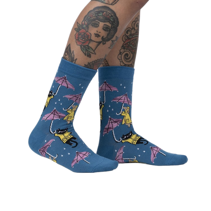 Lifestyle shot showcasing the 'Petting in the Rain' socks on a model's legs.