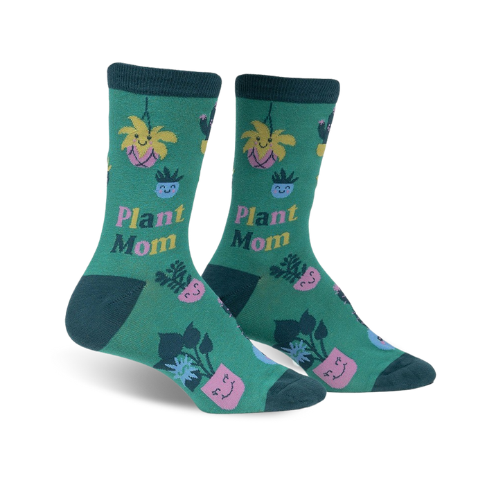 women's knee-high crew socks in dark green with pink, blue and yellow pots and smiley-face plants.   