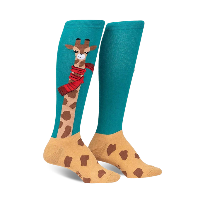 Pair of teal and tan knee-high socks featuring a whimsical giraffe design wearing a red scarf. }}