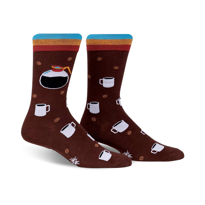 A pair of brown crew socks with a colorful stripe at the top. The socks feature a design of coffee pots, mugs, and coffee beans.