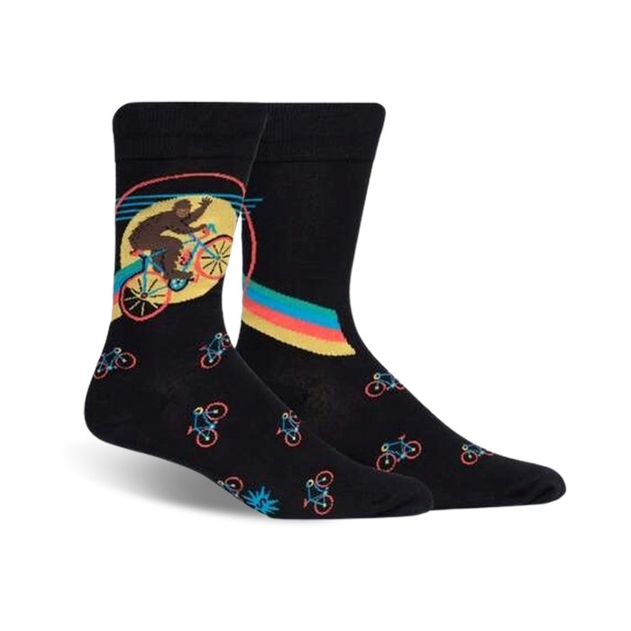 Pair of black crew socks featuring a Bigfoot riding a bike graphic. Smaller bike designs are repeated on the sock.