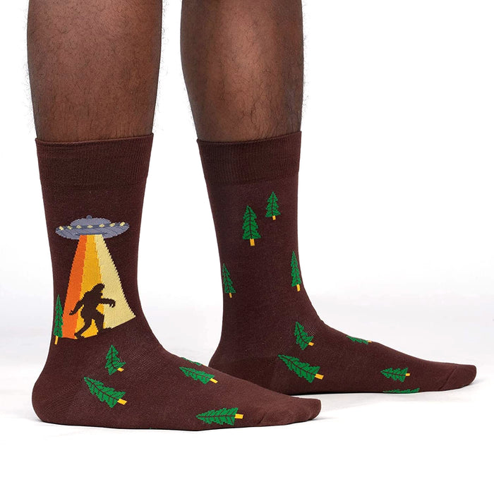 Lifestyle shot of a person wearing the Bigfoot and UFO crew socks. Shows how the socks look on.