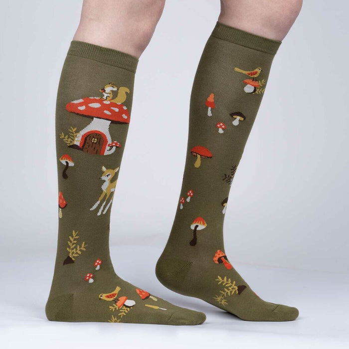 Close-up side view of the socks highlighting the details of the whimsical mushroom houses and woodland creatures.