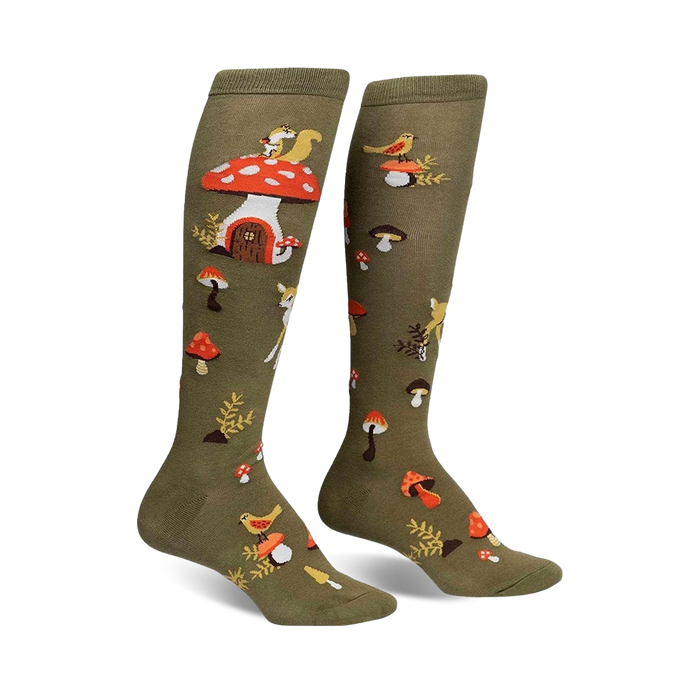 Pair of olive green knee-high socks with whimsical mushroom houses, squirrels, deer, and birds.  A charming forest design.