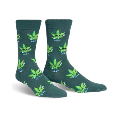 Pair of crew socks in dark teal with a pattern of cartoon marijuana leaves wearing sunglasses and giving peace signs.