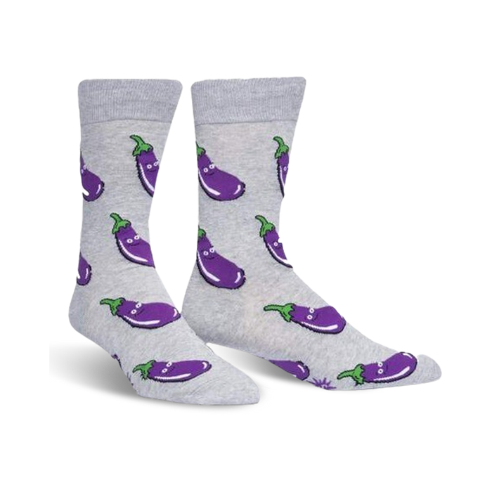 Pair of grey crew socks with a repeating pattern of smiling purple eggplants. Fun and quirky design. }}