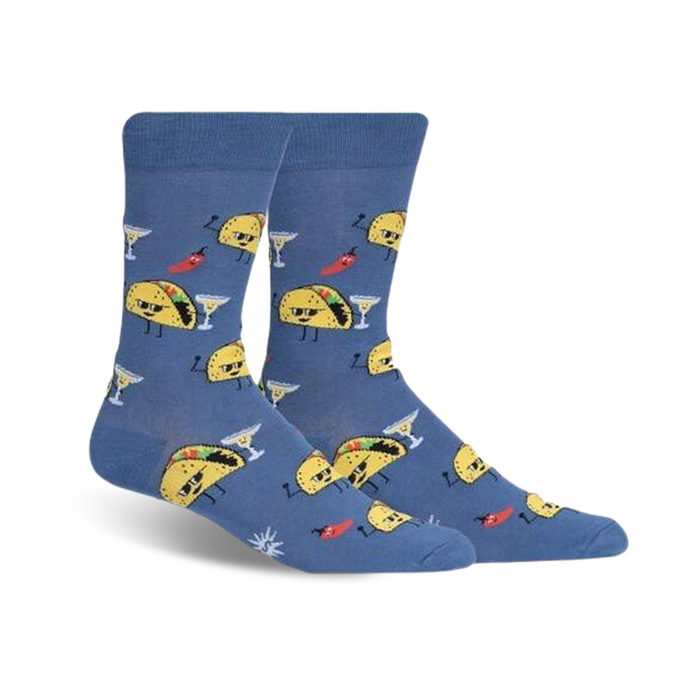 A pair of crew socks in blue featuring fun illustrations of tacos with sunglasses, margaritas, and chili peppers. }}