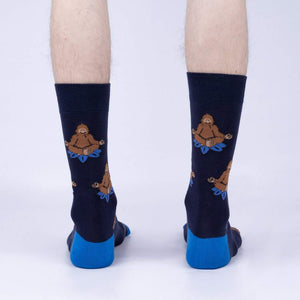 Back view of the Meditating Bigfoot socks worn on a person's legs. Shows the full design on each sock.