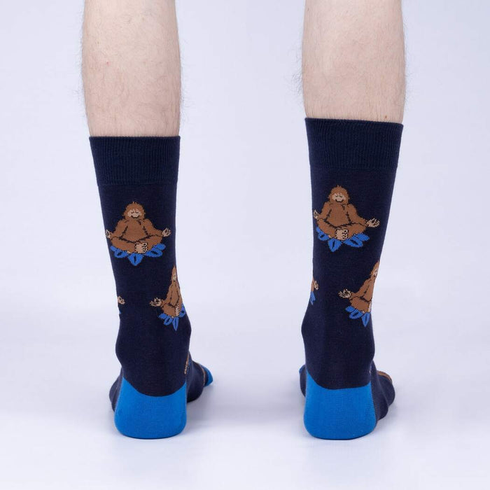 Back view of the Meditating Bigfoot socks worn on a person's legs. Shows the full design on each sock.