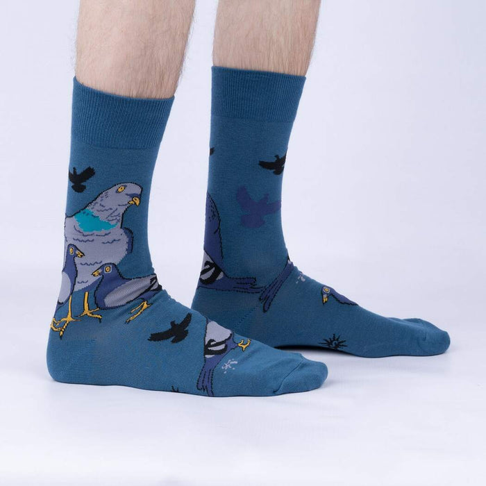 A pair of blue socks with a pattern of cartoon pigeons on them.
