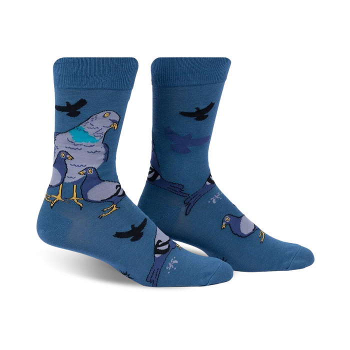 blue crew socks with a pattern of four pigeons on each sock: one large pigeon with light blue belly and yellow beak, and three smaller pigeons with grey bellies and orange beaks. pattern also includes small, black birds flying around the pigeons.  