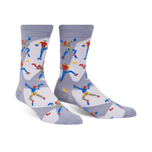 A pair of gray crew socks with a repeating pattern of illustrated rock climbers in red, blue, and yellow.