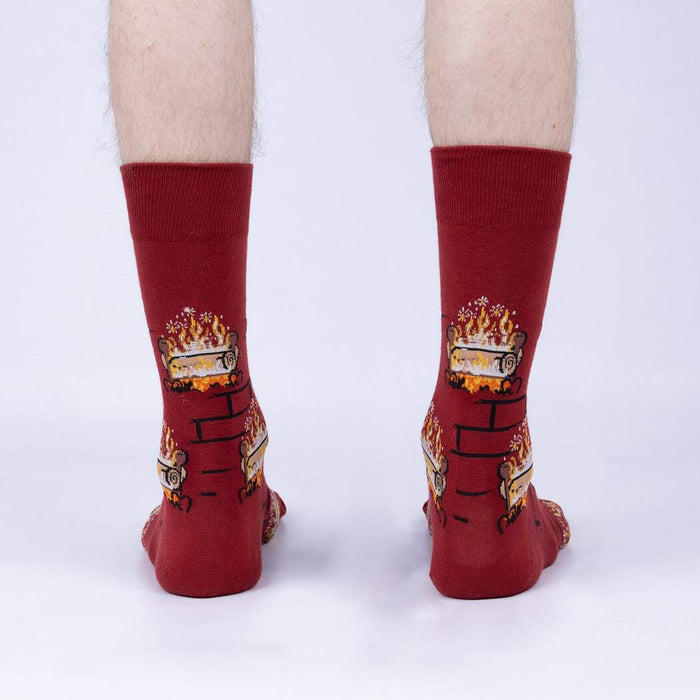 Rear view of a person wearing the Yule Log socks, showcasing the full design on the back of the socks.