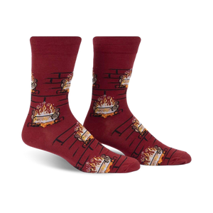 Pair of burgundy crew socks with a repeating pattern of burning yule logs in a fireplace.