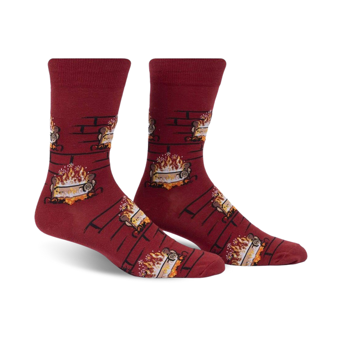 Pair of burgundy crew socks with a repeating pattern of burning yule logs in a fireplace.