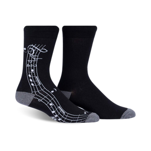 Pair of black crew socks with a white musical notation design on the side. Grey-toned cuffs.