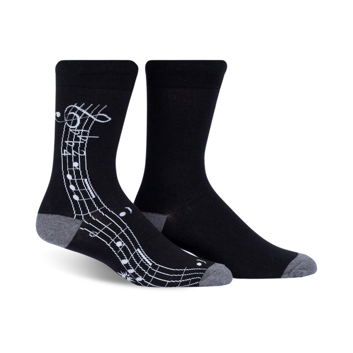Pair of black crew socks with a white musical notation design on the side. Grey-toned cuffs.