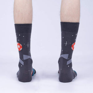 Rear view of 'Lets Kick It' socks worn on a person's feet showing the complete back of the sock design.