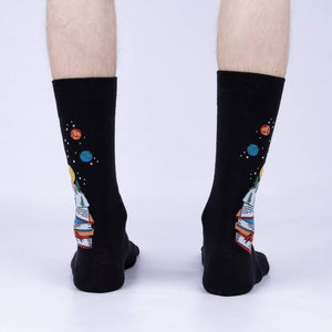 Rear view of the socks on a person's legs, highlighting the design on the back of the socks.