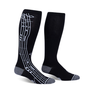 Pair of black knee-high socks with a white musical note design on the side. Grey accents at the cuffs.