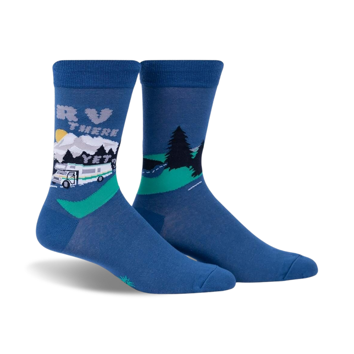 Pair of blue crew socks with a graphic design of an RV driving through a mountain landscape.  Features a whimsical sun and green trees.