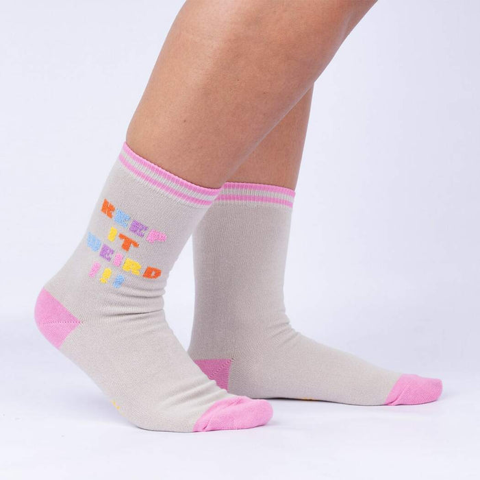 Lifestyle shot showcasing 'Keep It Weird!' socks on a person's legs, highlighting the fit and style.