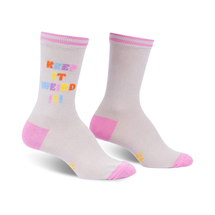 Pair of grey crew socks with a multicolored 'Keep It Weird!' text design and pink cuffs.