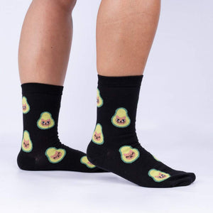 Lifestyle shot showing the socks on a person's legs.  The socks are black with a pattern of avocado cats.