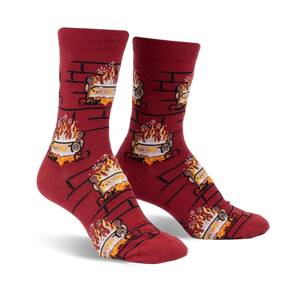 Pair of crew socks in burgundy with a repeating pattern of burning yule logs in a brick fireplace.