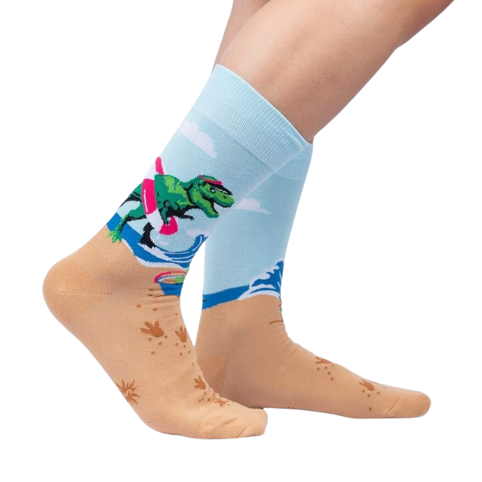 Lifestyle photo showing Dinos Gone Wild socks on a person's feet, showcasing the sock's fit and design on legs.