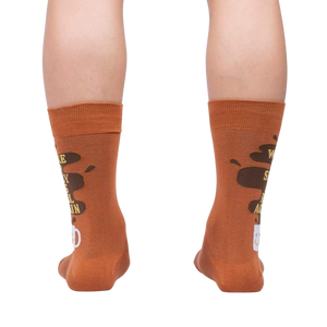 Rear view of the socks on a person's legs, highlighting the back design of the coffee cup and text.